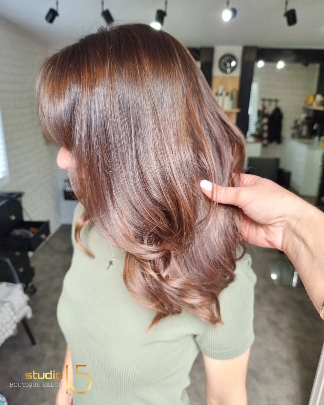 Brunette layered blowout with warm copper tones at Studio 15 Waipapa
