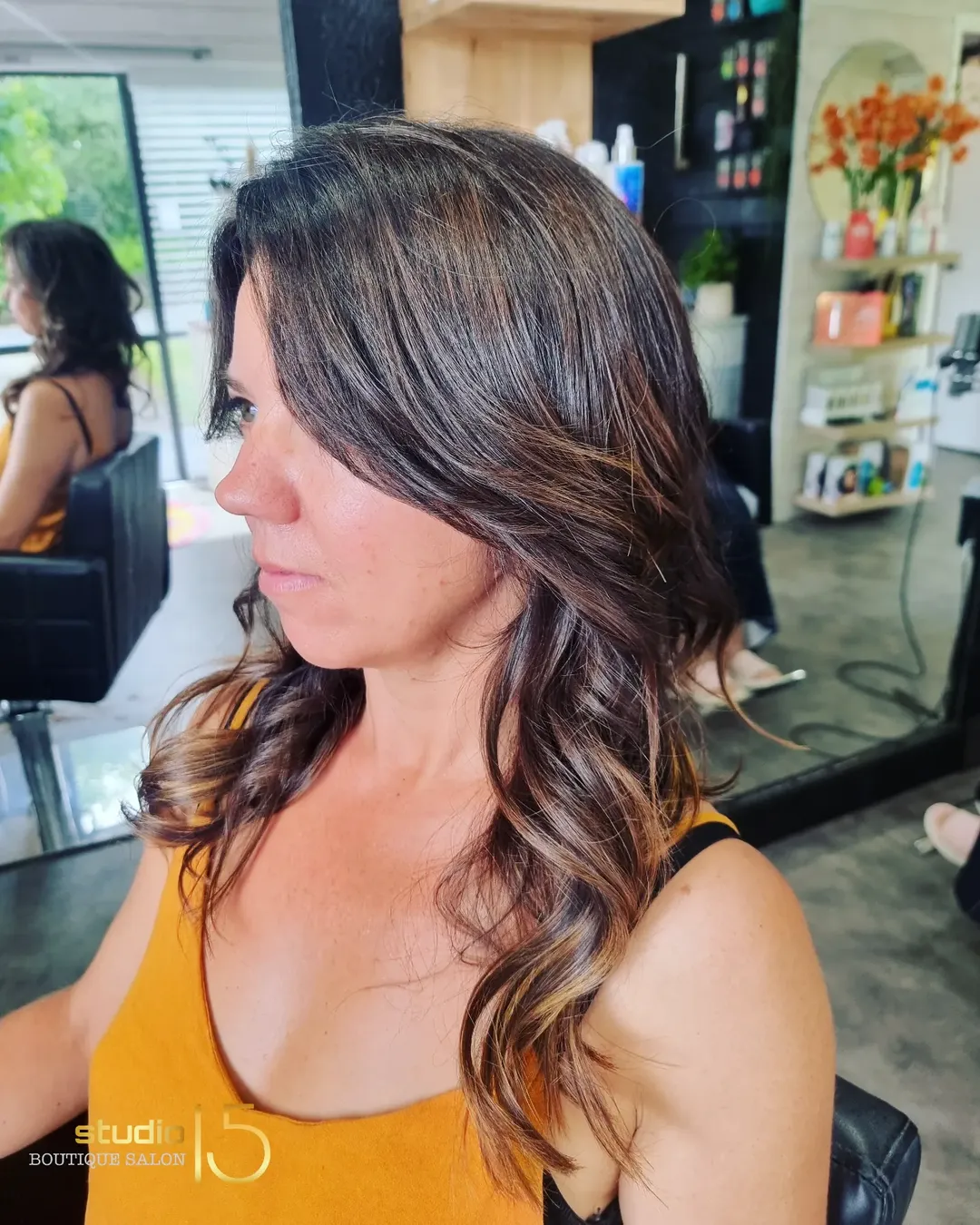 Brunette waves with caramel highlights at Studio 15 hair salon Northland