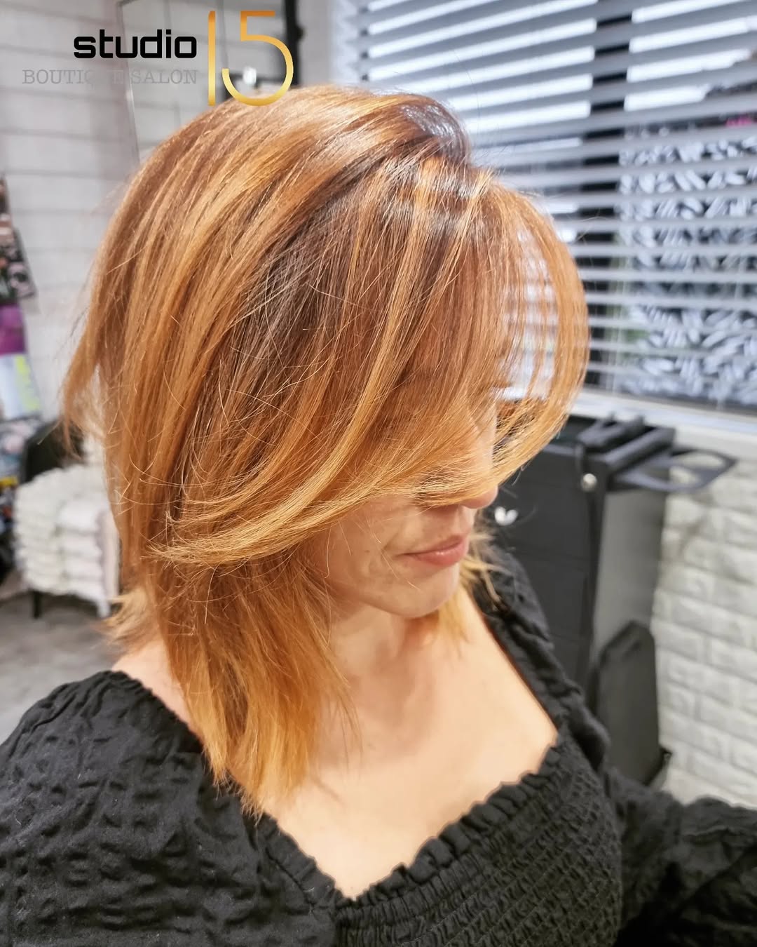 Copper ginger layered bob with warm highlights at Studio 15 Northland